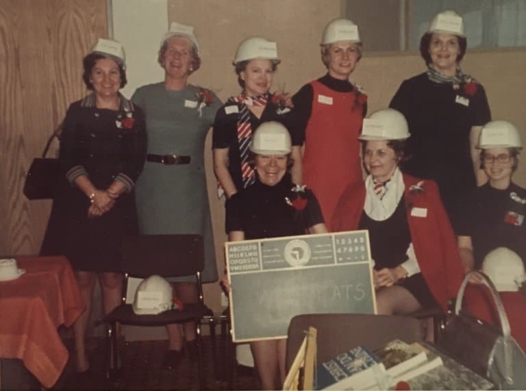 The first board of the Petroleum Wives Club, photographed in the fall of 1970. They are wearing white helmets, and one of them is holding a sign reading “Wildcats,” one of the proposed names for the club before “Petroleum Wives Club” was chosen.